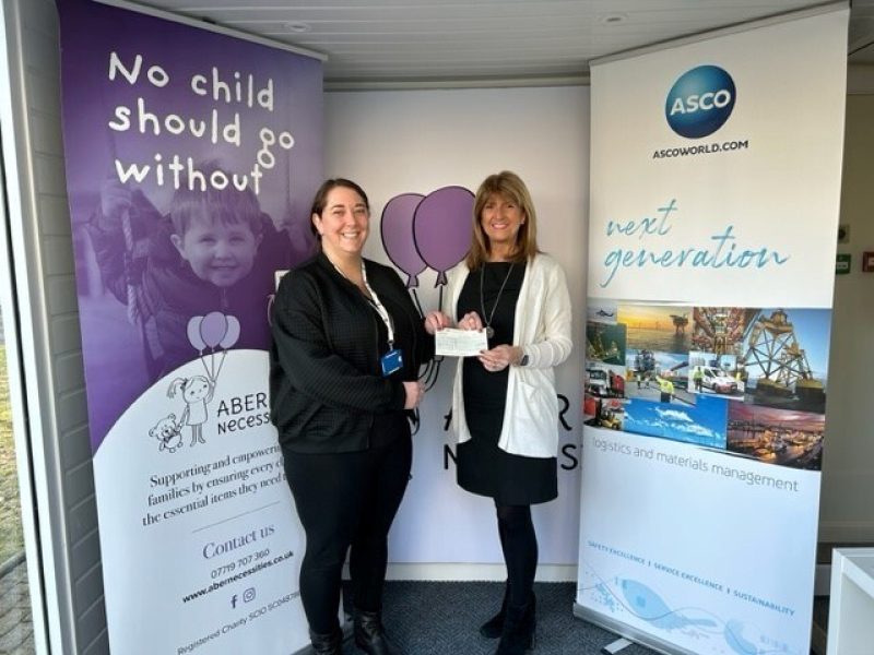 Katie Greig presenting a cheque to Aber Necesserites